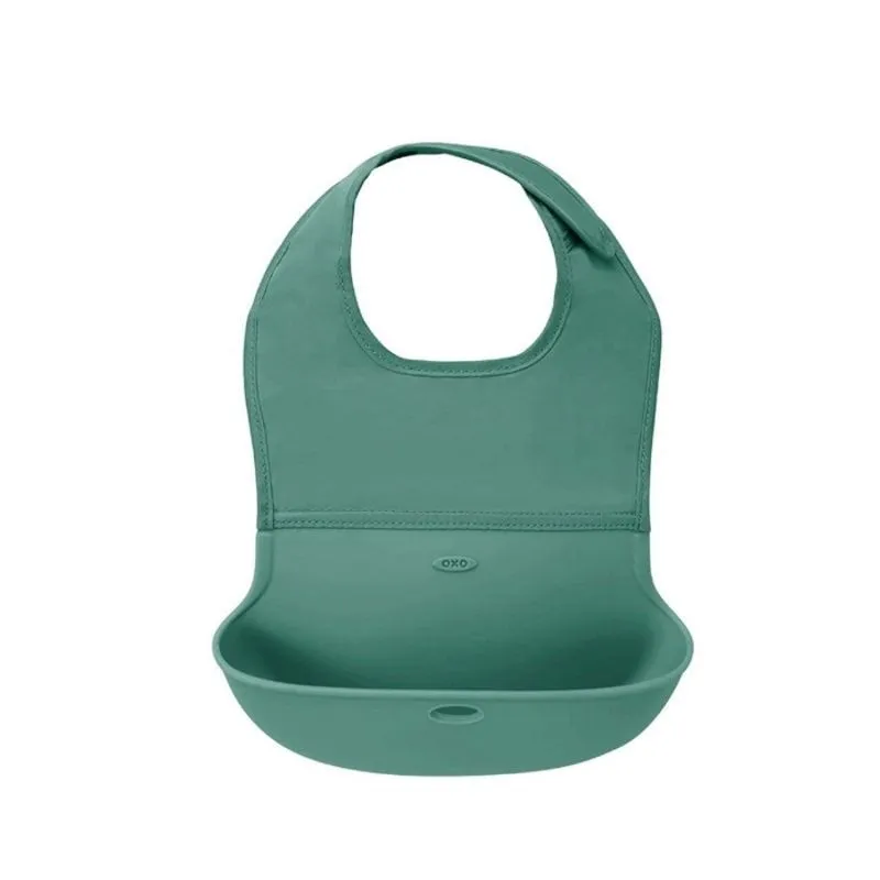 OXO silikoninis seilinukas su kišene - Prekės kūdikiams OXO silikoninis seilinukas su kišene - Prekės kūdikiams