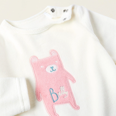 ZIPPY balti veliūriniai šliaužtinukai (0/1-18/24 mėn) iš arti, matosi užsegimas ir iliustracija